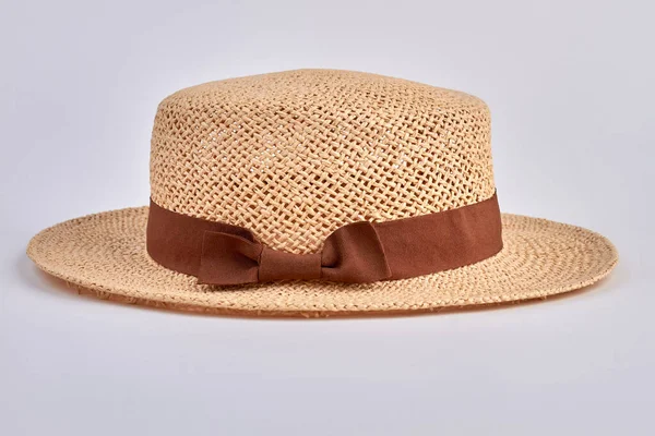 Straw womens hat with brown ribbon and bow. Isolated on white background. — Stock Photo, Image