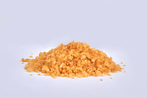 Pile of yellow bath salt isolated on white background. — Stock Photo, Image
