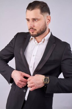 Sexy man puts on his jacket.