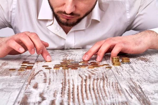 Pile of coins on the wooden table. Stock Picture