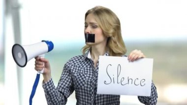 Silenced woman with megaphone can not speak.