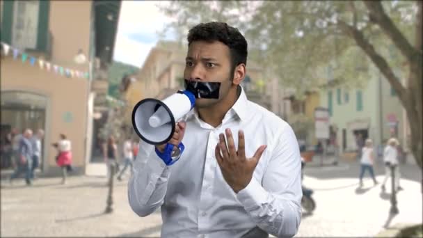 Expressive man with black tape over mouth. — Vídeos de Stock