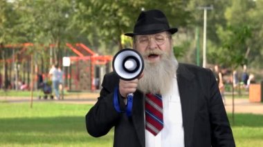 Old man announcing message with megaphone.