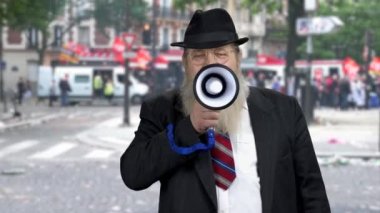 Senior businessman announcing a message through megaphone.