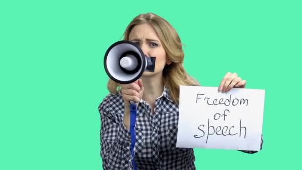 Freedom of speech concept. Young caucasian woman with megaphone. — Stock Video