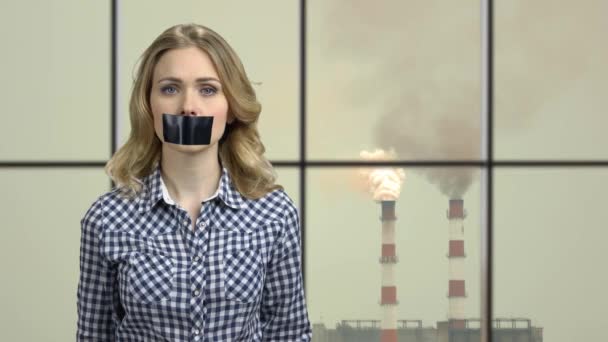 Woman with taped mouth looking at camera. — Vídeo de Stock