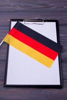 Clipboard with blank paper for copy space and flag of Germany.
