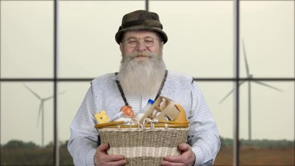 Hombre mayor presentando cesta con productos saludables. — Vídeos de Stock