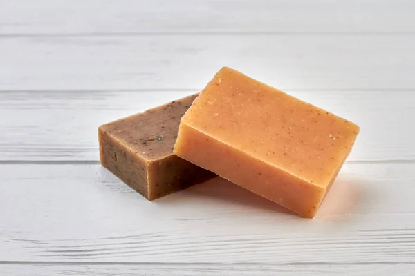 Two homemade brown spa soap on wooden table. — Stock Photo, Image