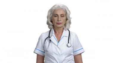 Beyaz arka planda gülümseyen kadın doktor portresi.