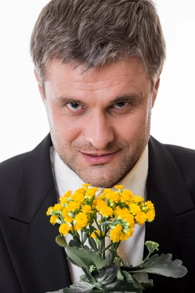 Adult male with flowers. — Stock Photo, Image