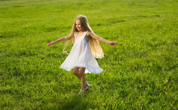 Little girl running along the meadow. — Stock Photo, Image
