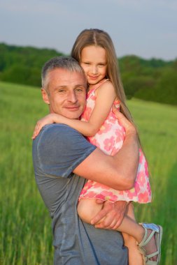 Father and daughter in the field.