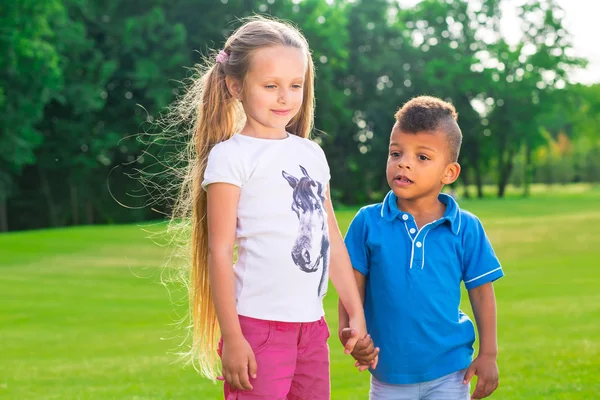 Two kids on the glade. — Zdjęcie stockowe