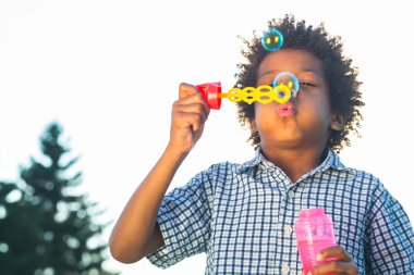 Sevimli çocuk kabarcıklar yapıyor.
