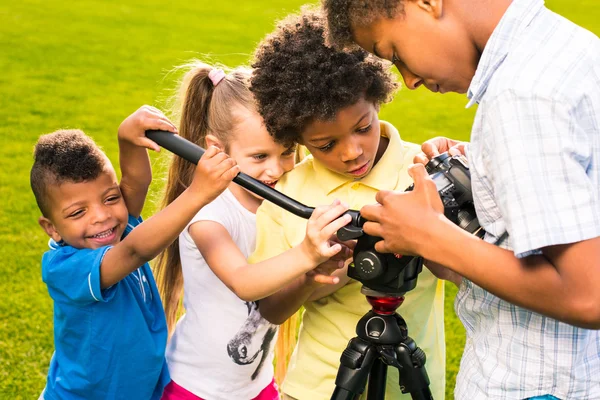 Kids are holding a camera. — Stock fotografie