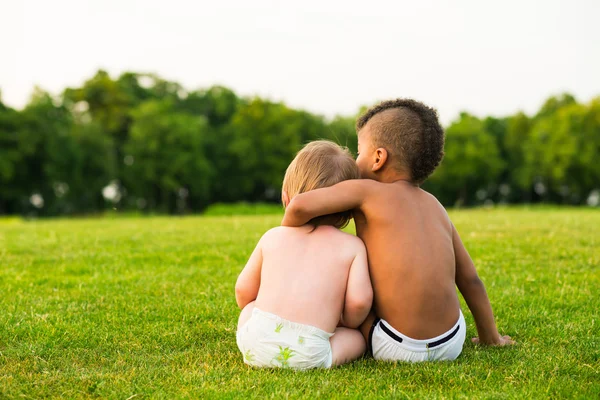 Two children on the evening glade. — Stock fotografie