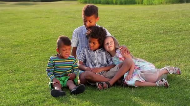 Vier kinderen spelen op de glade. — Stockvideo
