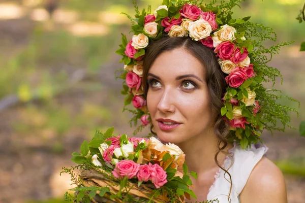 Attractive woman in wreath of flowers. — Stock Photo, Image