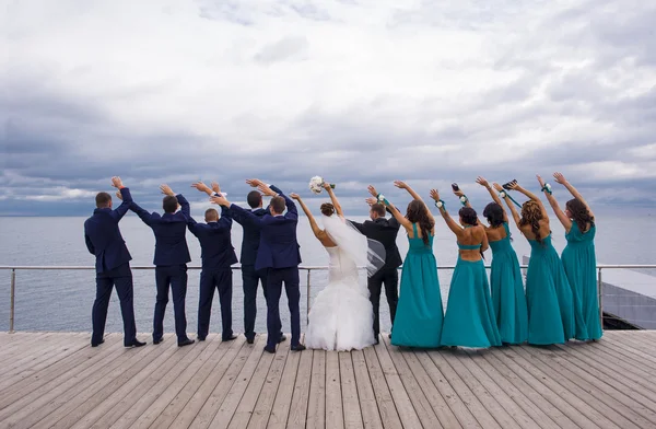 Guests on the wedding celebration are holding their hands up wit — Stock Photo, Image