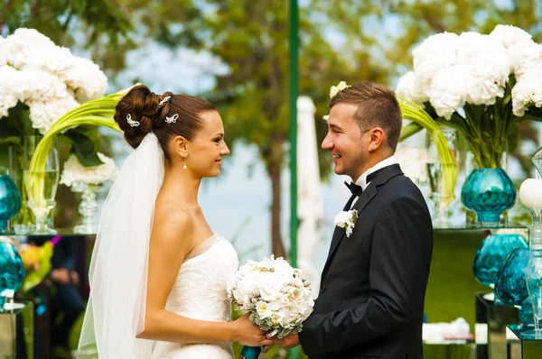 Os recém-casados estão sorrindo durante a cerimônia de casamento . — Fotografia de Stock