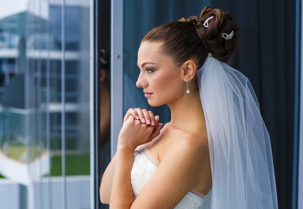 Bride are looking through the window. — Stock Photo, Image