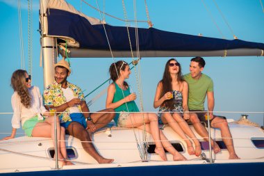 Cheerful young people relaxing on a yacht.