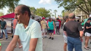 Orlando, Florida, ABD - 03.16.2024: İnsanlar etkinlik sırasında gıda standları ve çadırların etrafında yürüyor. İnsanlar Amerikan yemeği kuyruğunda bekliyor..