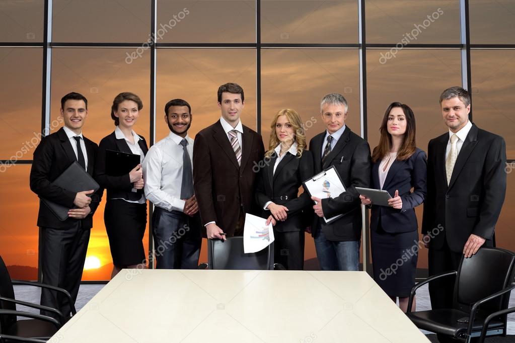 Business people on the background of sunset.