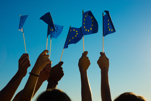 People holding flags of the European Union.