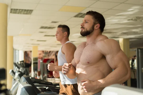 Two sportsmen in gym. — Stock Photo, Image