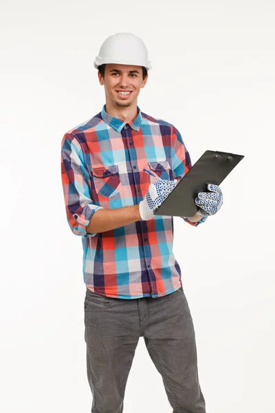 Handsome young engineer with clipboard. — Stock Photo, Image