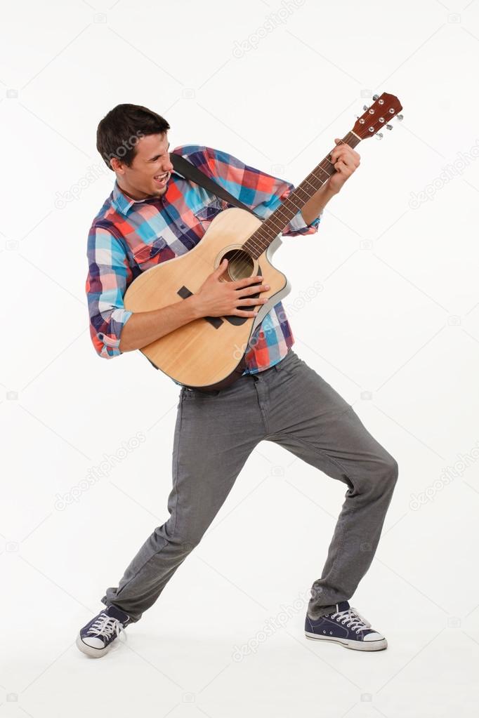 Emotional musician playing his guitar.