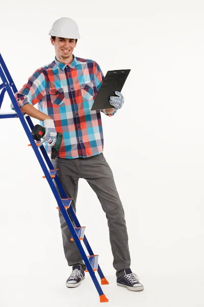 Constructor with hand drill on ladder. — Stock Photo, Image