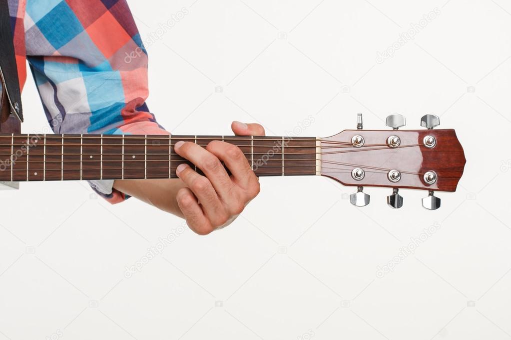 Fingerboard of guitar and hand playing guitar.