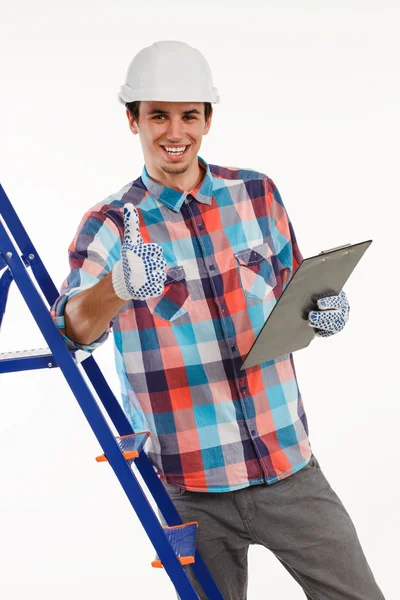Handyman stood by ladder giving thumbs-up. — Stock Photo, Image