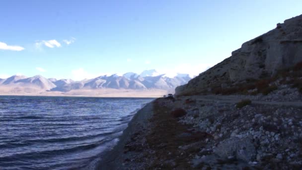 Mapam Yumco (Manasarovar) Gölü ve geçen arabalar Tibet'te. — Stok video
