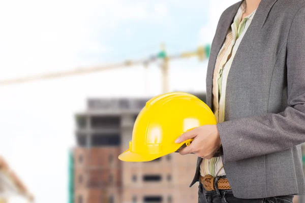 Engineer holding yellow helmet for workers security on backgroun — Stock Photo, Image