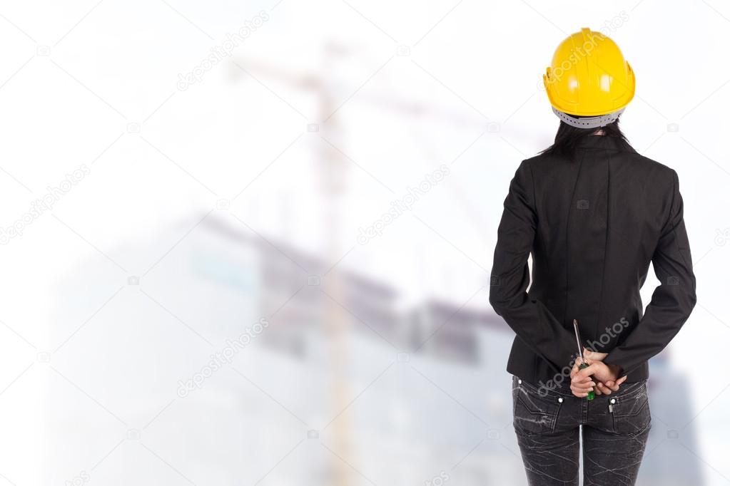 Worker and the blurred construction in background with space for