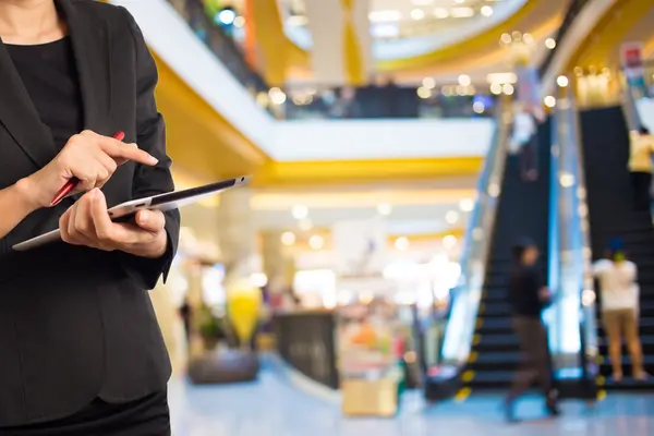 Kvinna med hjälp av Tablet PC i köpcentrum. — Stockfoto