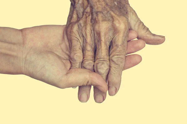 Mão de mulher tocando mulher idosa. : Filtro vintage — Fotografia de Stock