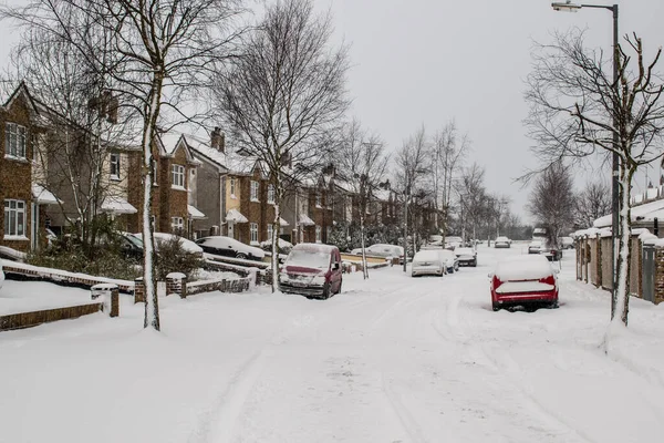 Street of residential houses . Family houses in snow on winter season