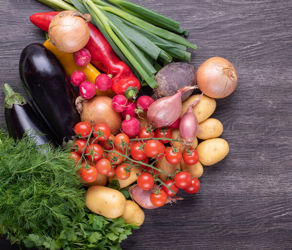 Fresh colorful organic vegetables on a rustic wooden table background, farming and healthy food concept.