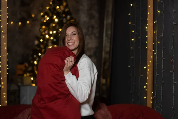 Happy girl lying on cozy bed. Christmas concept.