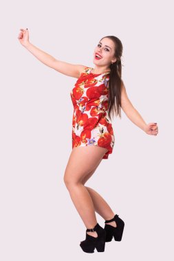 Kısa kırmızı elbiseli baştan çıkarıcı genç kadın. 