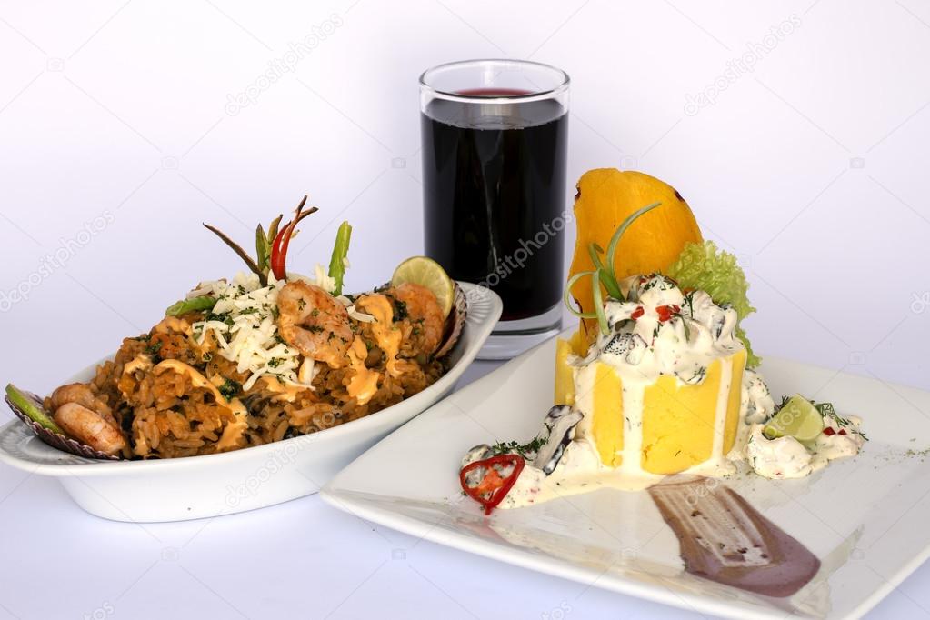 Peruvian Food: Causa Rellena, A smashed popatoes filled with crab meal and Rice with sea food. 2 dishes served as a main meal with a glass of chicha morada (purple  corn juice).