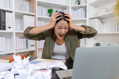 Ağır iş baskısı ile uğraşan stresli iş kadını, raporları incelerken duygusal tepki verirken ve son teslim tarihleriyle yüzleşirken, işyeri stresi ve modern mesleki zorlukları vurguluyor.