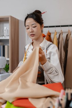 Moda tasarımcısı kıyafet modelleri ve terzilik planları yaparken yeni moda koleksiyonu için yaratıcı giysiler geliştiriyor..