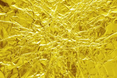 Parlak altın folyo dokusu, buruşuk ve dalgalı ambalaj kağıdı deseni