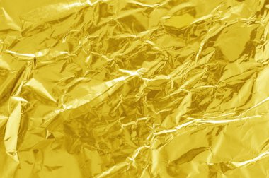 Parlak altın folyo desenli arka plan, buruşuk ve dalgalı sarı ambalaj kağıdı deseni.